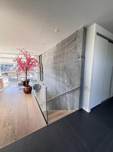 a staircase in a house with a large wall at Luxury Villa with Heated Pool & Sea View Your Private Paradise on the Norwegian Coast in Kristiansand