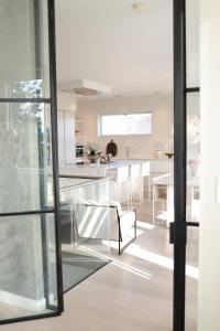 a kitchen and dining room with a glass table at Luxury Villa with Heated Pool & Sea View Your Private Paradise on the Norwegian Coast in Kristiansand