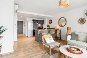 a living room and kitchen with a couch and a table at Alamanda 114 - 2 bedroom apartment with OceanView in Orient Bay