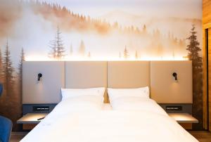 a bedroom with two beds and a mural of trees at Apartment 1 - Schmiedefeld - klein und fein in Schmiedefeld am Rennsteig