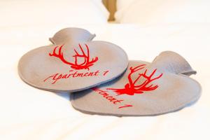two hearts with antlers on them on a bed at Apartment 1 - Schmiedefeld - klein und fein in Schmiedefeld am Rennsteig