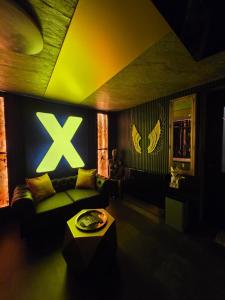 a living room with a green couch and a table at eroXens in Saint-Amand-les-Eaux