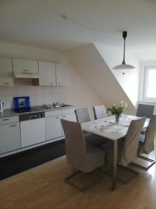 a kitchen and dining room with a table and chairs at Ferienwohnung am Bodensee mit 3 Schlafzimmer über 2 Etage mit kleine Balkon bis 6 Personen in Überlingen +27 photos