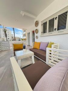 a living room with a couch and a table at Makenzy Mermaid 2 Bedroom Apartment in Larnaca