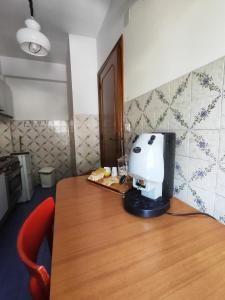 a coffee maker sitting on top of a wooden table at Appartamento l'ara in Scanno +3 photos