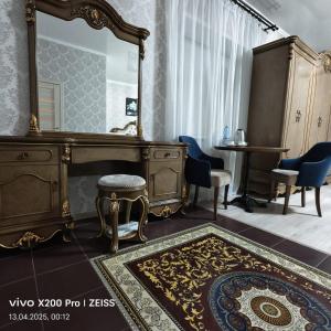 a dressing room with a mirror and a dressing table at Отель при ресторане Sultan Sarayi in Kostanay +8 photos