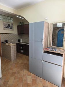 a kitchen with a large stainless steel refrigerator at Dimora Sogno Suite in Termoli