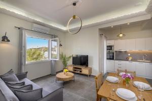 a living room with a couch and a table at Elia Syros in Vári