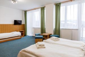 Postel nebo postele na pokoji v ubytování Hotel Tatrawest