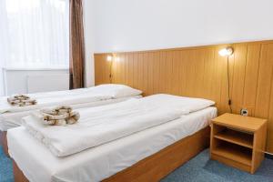 Postel nebo postele na pokoji v ubytování Hotel Tatrawest