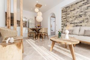 a living room with a couch and a table at Ruby of Naxos Residences in Kastraki +52 photos