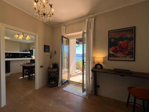 a living room with a door leading to a patio at Raggio di Sole Villa in Oggebbio