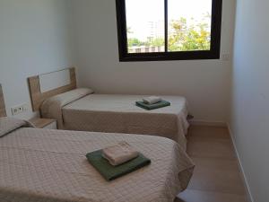 Postel nebo postele na pokoji v ubytování Residencial El Trenet 2A