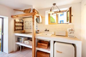 a kitchen with a sink and a counter at The Indigo Windmill Retreat, Peniche in Atouguia da Baleia
