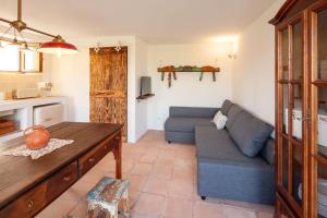 a living room with a couch and a table at The Indigo Windmill Retreat, Peniche in Atouguia da Baleia
