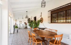 a dining room with a wooden table and chairs at Comfortable villa with mountain views - Valverde de Leganés in Valverde de Leganés