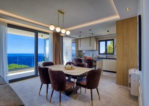 a kitchen and dining room with a table and chairs at La Dolce Villa in Dubrovnik