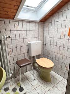 a bathroom with a toilet and a stool at Beim Bergfreund in Füssen +61 photos