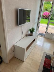 a white desk with a tv on a wall at Ascona Principessa Apt 3 in Ascona +11 photos