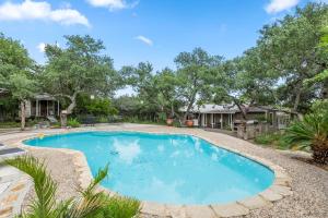 a swimming pool in a yard with trees at OT 2905 BellaVida Haus in New Braunfels