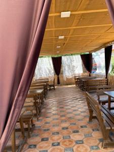 an empty church with wooden benches and curtains at Yasina in Bosteri