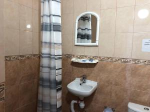 a bathroom with a sink and a mirror at Готель Оазис in Chernivtsi +61 photos