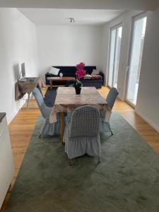 a living room with a wooden table and chairs at AVIZJA Living in Korneuburg