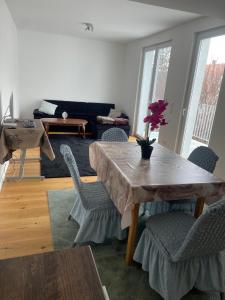 a living room with a wooden table and chairs at AVIZJA Living in Korneuburg +32 photos