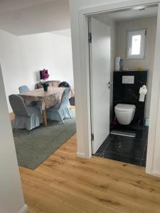 a living room with a table and a dining room at AVIZJA Living in Korneuburg