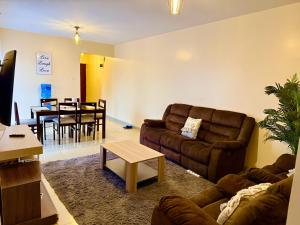 a living room with a couch and a table at Luxe Haven in Eldoret