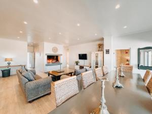 a living room with a table and chairs and a fireplace at Simplicity 2 in Agulhas