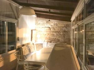 a table and chairs in a room with a stone wall at Charmante Ferienwohnung 2 im Schmöllerhäuschen in Stadt Wehlen +11 photos