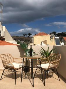 a patio with a table and chairs on a balcony at Gaia Luxury Rooms Rethymno in Rethymno