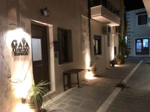 a building with a sign on the side of it at Gaia Luxury Rooms Rethymno in Rethymno