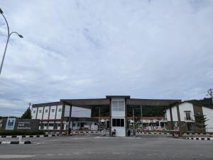 a large building with a parking lot in front of it at One Family Homestay Kulim in Kulim