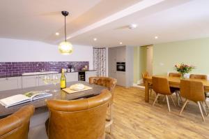 a kitchen and dining room with a table and chairs at Skelwith Fold Cottage No.3 in Elterwater