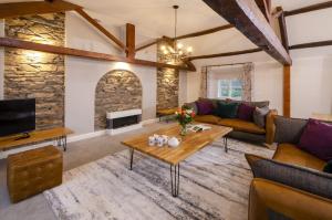 a living room with a couch and a table at Skelwith Fold Cottage No.3 in Elterwater
