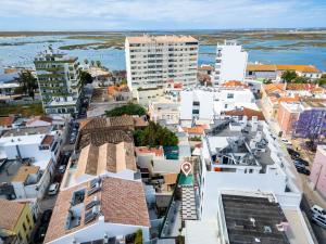 an aerial view of a city with buildings at Roots Hotel in Faro