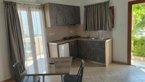 a kitchen with a table and a table and a dining room at Smaragda Hotel in Marathokampos +19 photos