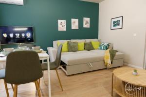 a living room with a couch and a table at Namaste apartment - cozy, central and relaxing stay near AUBG, freshly renovated in Blagoevgrad