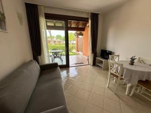 a living room with a couch and a table at Le Corti Del Lago in Padenghe sul Garda