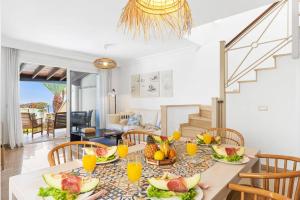 a dining room with a table with fruit on it at Villa Amara by Villa Plus in Chayofa