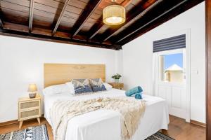 a bedroom with a large bed with a wooden ceiling at Villa Amara by Villa Plus in Chayofa