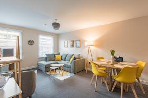 a living room with a couch and a table at Strand Apartment by Keepers Cottages in Deal