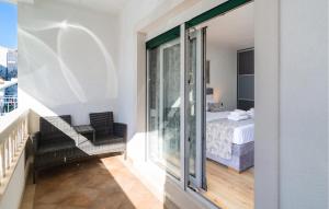 a room with a balcony with a bed and a bedroom at 1 Bedroom Nice Apartment In Hvar in Hvar