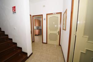 a hallway with a white door and a staircase at Da Piero e Gina in Palidoro