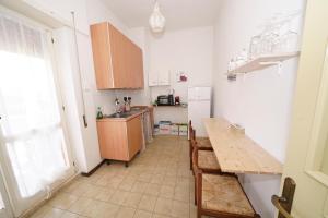 a kitchen with a wooden table and a counter at Da Piero e Gina in Palidoro