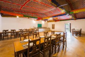 斋沙默尔Sky Desert Safari Camp Jaisalmer的用餐室配有木桌和椅子