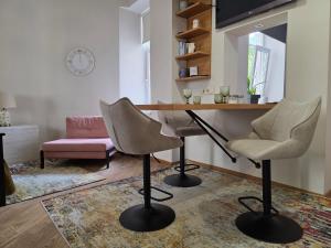 a living room with a table and two chairs at Apartment in the Heart of Old Riga in Rīga