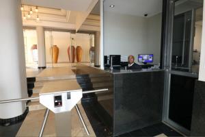 a man sitting at a desk in a lobby at Surfers Empire Penthouse in Muizenberg +30 photos